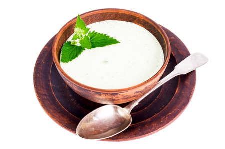 Tzatziki from cucumber and greek yogurt in ceramic bowl, isolated on white. Mint leaves. Studio Photoの写真素材