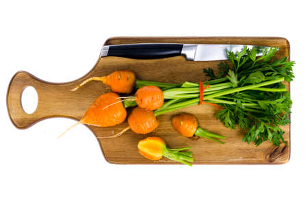 Bunch of small, round carrots (Parisian Heirloom Carrots) on wooden background. Studio Photoの写真素材