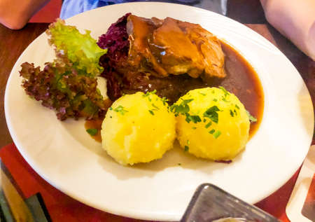 Tasty stewed meat, red cabbage and potato dumplings. Photo Studioの写真素材