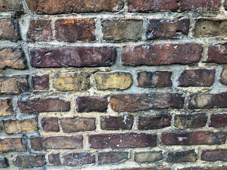 Antique red tempered brick wall. Part of the wall of an ancient building.