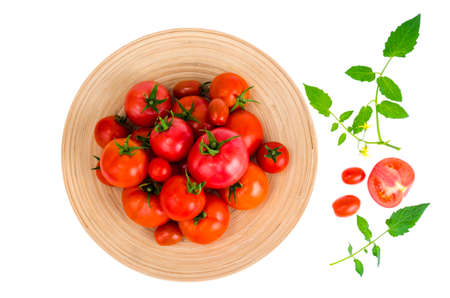 Wooden dish with different ripe tomatoes on white background. Studio Photoの写真素材