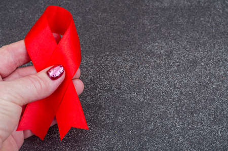 World AIDS Day, red ribbon, symbol. Studio Photo
