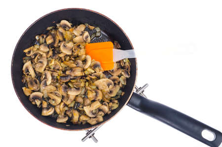 Pan with fried champignons on white plate. Studio Photoの写真素材
