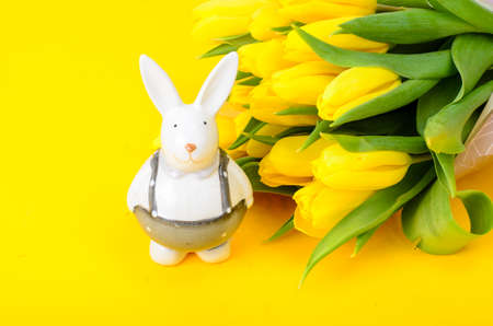 Easter souvenirs and bouquet of fresh flowers, Easter celebration concept
