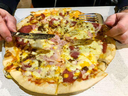 Pizza with salami, bacon and mozzarellaの写真素材