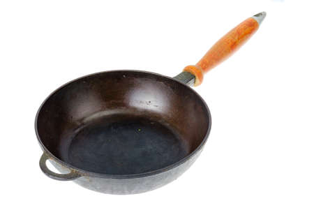 Cast iron black pan with wooden brown handle isolated on white background. Studio Photoの写真素材