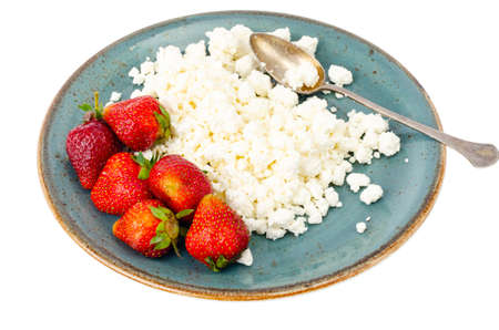 Healthy food. Fresh homemade cottage cheese and strawberries. Studio Photo