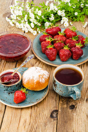 Ripe red sweet strawberry jam, fresh berries on wooden table. Studio Photoの写真素材