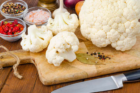 Head of cabbage fresh organic cauliflower on wooden background, spices.の写真素材