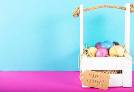 Colorful background with Easter eggs on pink and blue background. Happy Easter concept. Can be used as poster, background, holiday card. Flat lay, top view, copy space.の写真素材