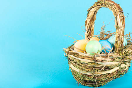 Colorful background with Easter eggs on blue background. Happy Easter concept. Can be used as poster, background, holiday card. Flat lay, top view, copy space.の写真素材
