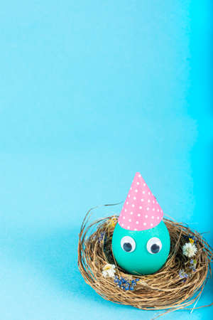 Colorful background with Easter eggs on blue background. Happy Easter concept. Can be used as poster, background, holiday card. Flat lay, top view, copy space.の写真素材