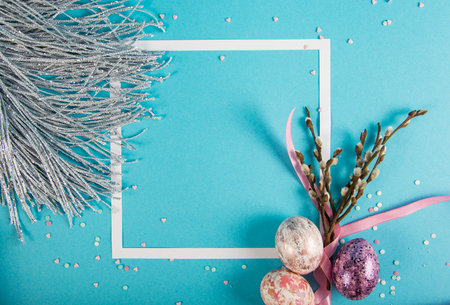 Colorful background with frame, Easter eggs on blue background. Happy Easter concept. Can be used as poster, background, holiday card. Flat lay, top view, copy space. Studio Photoの写真素材