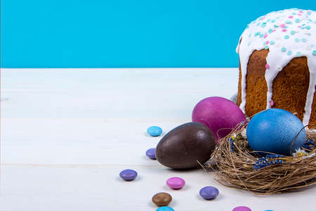 Colorful background with Easter eggs on white wooden board background. Happy Easter concept. Can be...