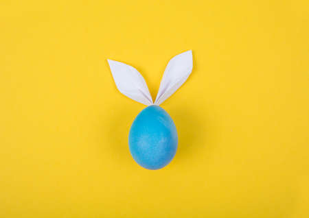 Egg with paper ears in the shape of an Easter bunny. Happy Easter Concept Card Postaer Background. Studio Photoの写真素材