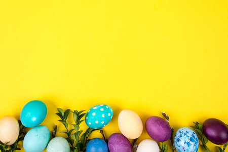 Colorful background with Easter eggs on yellow background. Happy Easter concept. Can be used as poster, background, holiday card. Studio Photoの写真素材