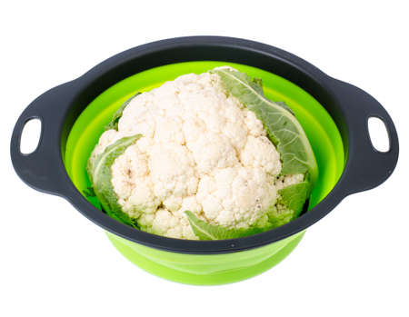 Head of fresh cauliflower in colander on white background. Studio Photoの写真素材