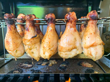 Grilled chicken drumsticks are cooked in gas grill.の写真素材