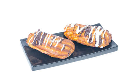 Iced custard cakes with cream, confectionery. Photo