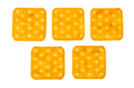 Delicious golden salt cracker cookies isolated on white background. Studio Photo