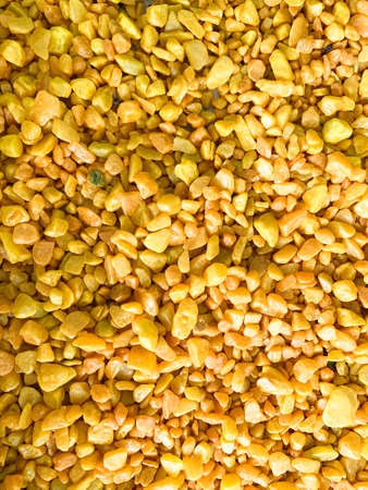 Background from decorative yellow small pebbles.