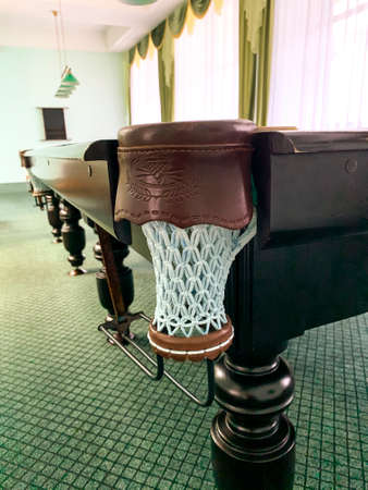 The table for billiards is in room.
