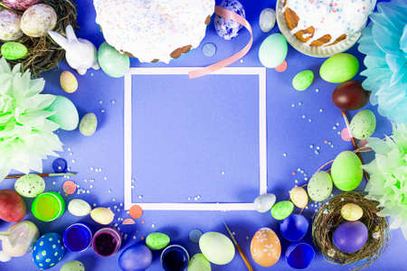 Colorful background with Easter eggs on blue background. Happy Easter concept. Can be used as poster, background, holiday card. Flat lay, top view, copy space.の写真素材