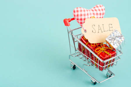 Seasonal sales. Shopping cart shopping cart on bright background. Studio Photoの写真素材