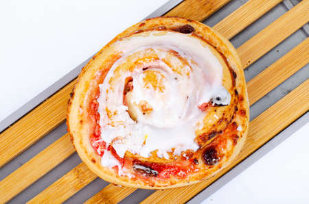 Sweet bun with raisins and white sugar icing. Studio Photoの写真素材