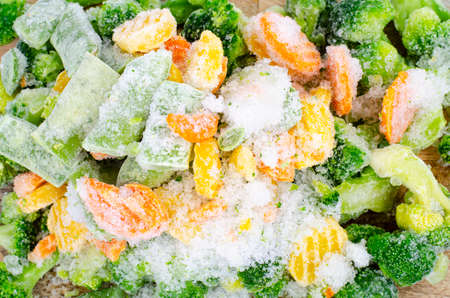 Raw frozen bio vegetables on wooden cutting board. Studio Photoの写真素材