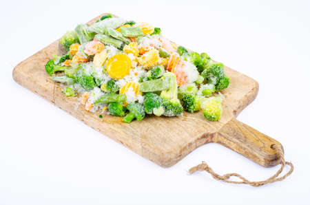 Raw frozen bio vegetables on wooden cutting board. Studio Photoの写真素材