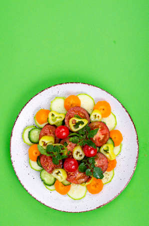 Healthy food concept. pPlate with chopped fresh vegetables on bright background. Studio Photo.の写真素材