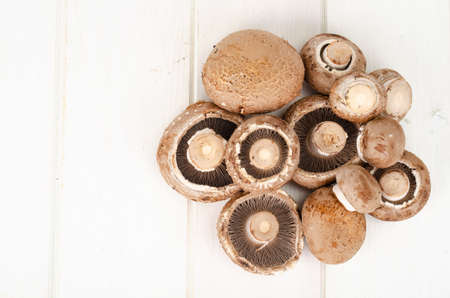 Fresh brown cultivated mushrooms champignons on wooden background. Studio Photo.の写真素材