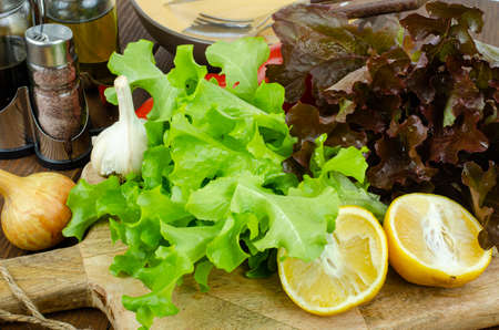 lettuce leaves on wooden cutting board, set of spices for cooking. Studio Photoの写真素材
