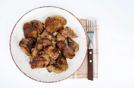 Cooked chicken liver on plate. Liver dishes. photo