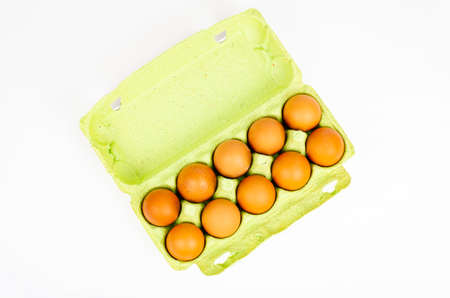 Colored fresh chicken eggs in cardboard. Studio Photo.