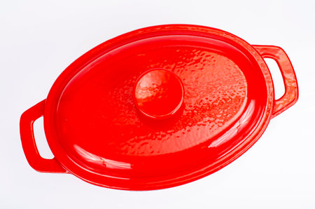 Red ceramic cast iron casserole dish. Studio Photo.の写真素材
