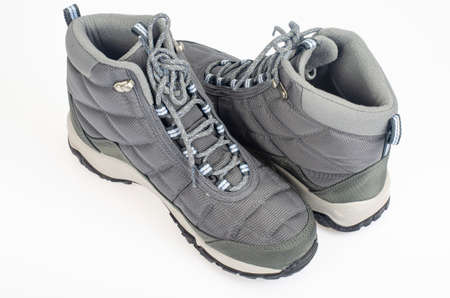 Winter waterproof insulated sports shoes on white background. photo