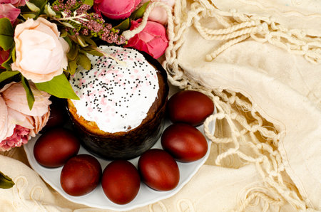 Preparation for celebration of Easter. Homemade cake and red colored eggs. photo