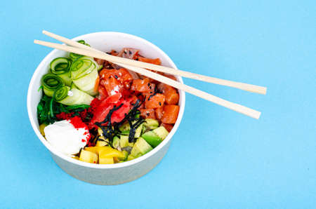 Poke with sea food and vegetables on blue background. photoの写真素材
