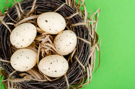 Top view of color easter haqndmade eggs and nest flatlay. Trendy minimal design spring background....
