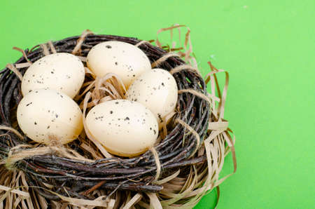 Top view of color easter haqndmade eggs and nest flatlay. Trendy minimal design spring background. Space for text. photoの写真素材
