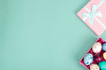 Multicolored eggs in open gift box. Concept of the Happy Easter holiday, greeting card template. photoの写真素材