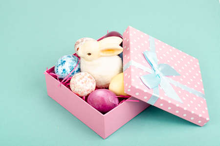 Multicolored eggs in open gift box. Concept of the Happy Easter holiday, greeting card template. photoの写真素材
