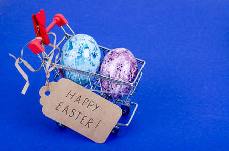 Grocery supermarket cart filled with chicken eggs. Concept of preparing for Easter, buying food. Space for text. photoの写真素材