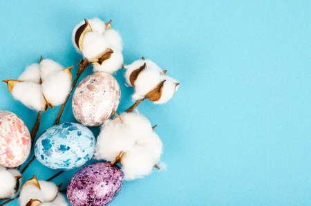 Easter background, color handmade eggs on blue background, decorated with cotton, space for text. happy holiday. photoの写真素材