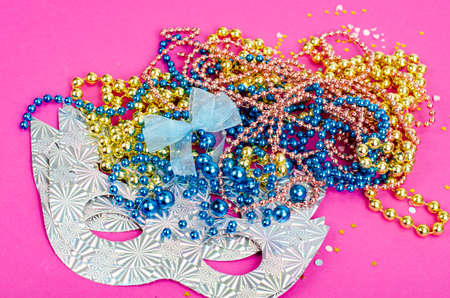 Color mardi gras beads, masks on bright background. photoの写真素材