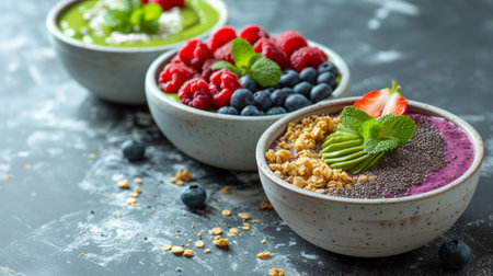 Acai bowls, chia seed puddings, and green smoothies are elegantly arranged on marble surfaces.の素材