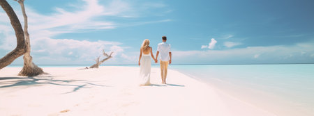couple walking on a tropical white sandy beach.の素材