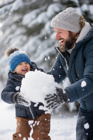 Dad and son enjoy a snowy day, playful snowball fights.の素材